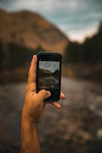 mobile phone person taking photo of mountain cell phone
